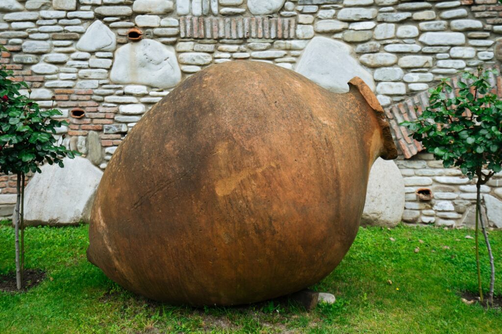 Large pottery amphora lying at brick wall