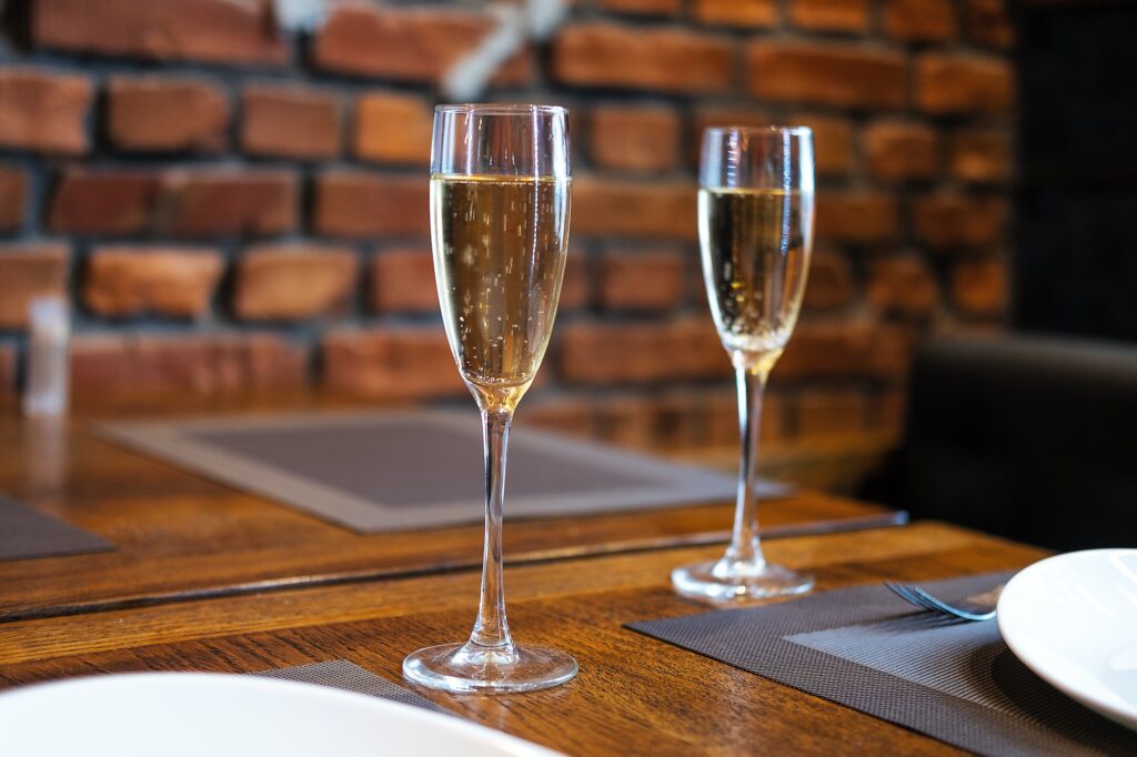 Two glasses of sparkling wine on table in reastaurant