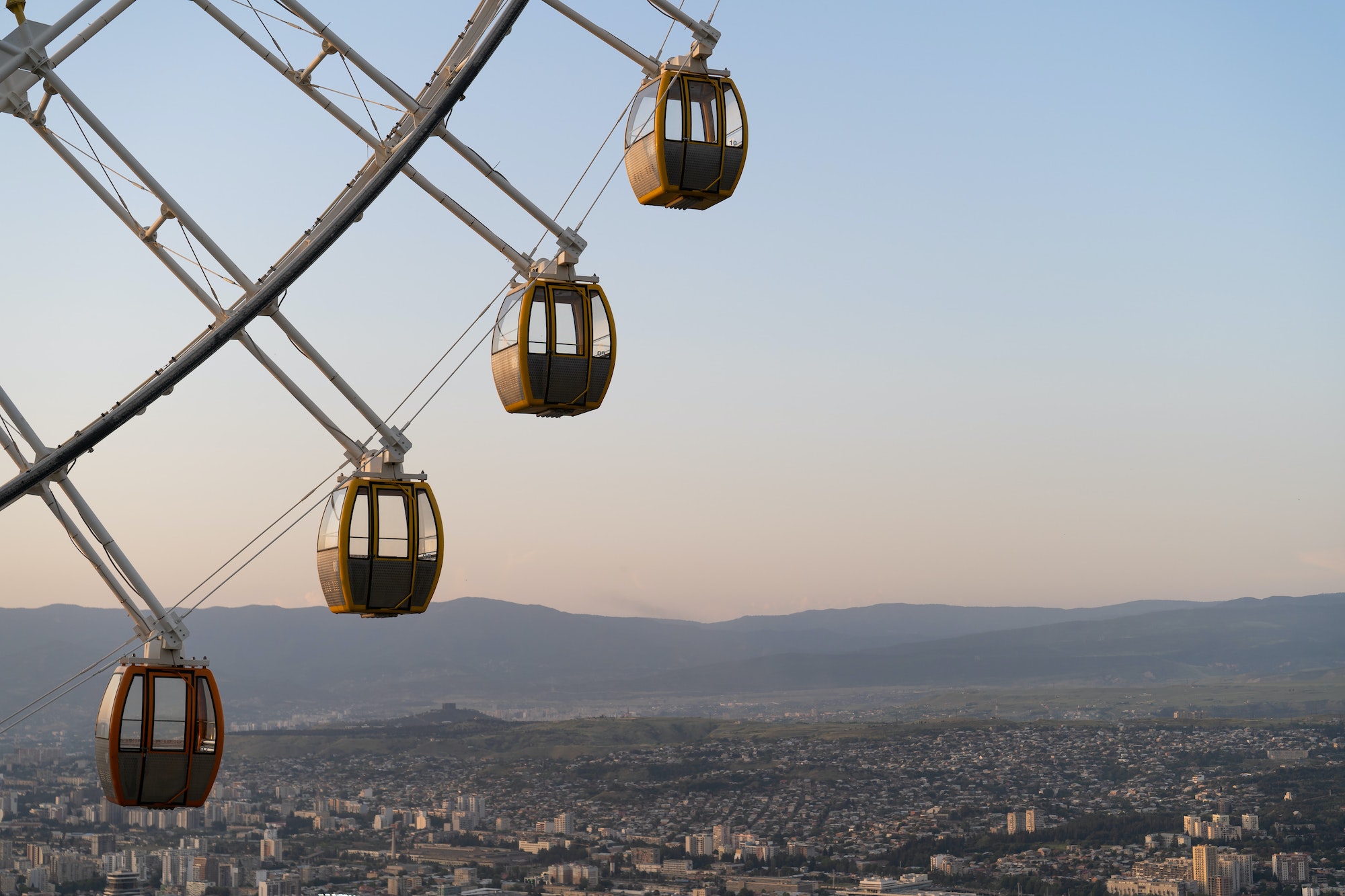 Ferris wheel in Mtatsminda amusement park in Tbilisi, Georgia. Giant wheel at sunset